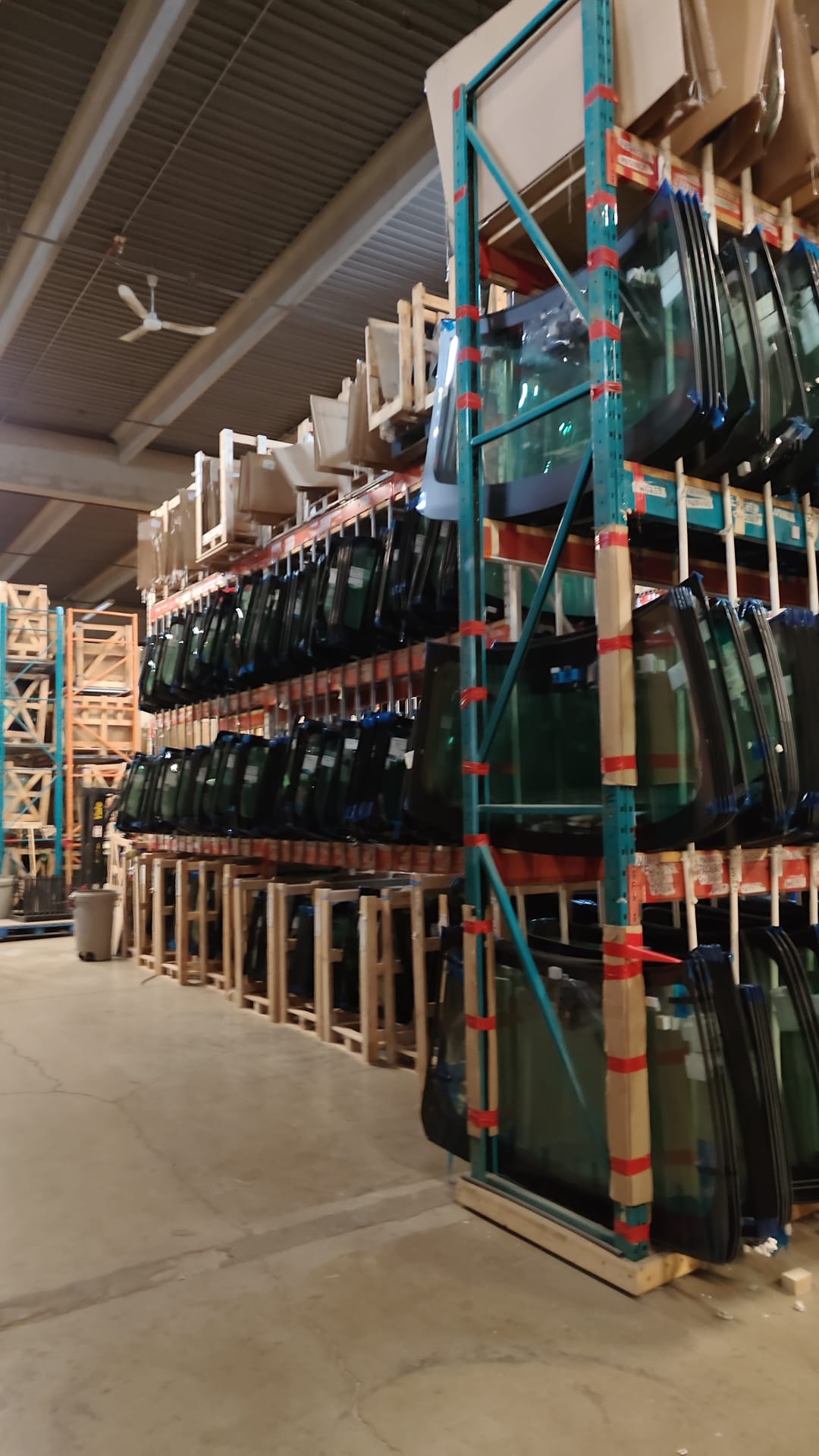 Windshields stocked on warehouse racks at Winaris Glass